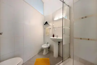a white bathroom with a toilet and a sink at A Casa Formosa in Porto