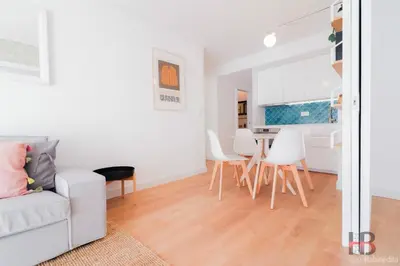 a living room with a white couch and a table at Good Vibes Only by LovelyStay in Porto