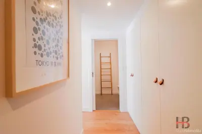 a hallway with a white wall and a ladder at Good Vibes Only by LovelyStay in Porto