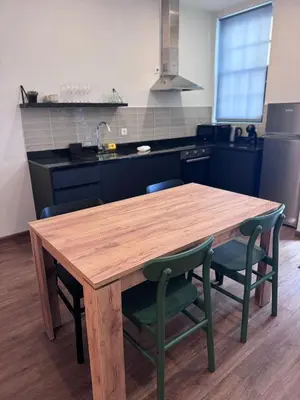 a kitchen with a wooden table and chairs at River Apartment in Porto