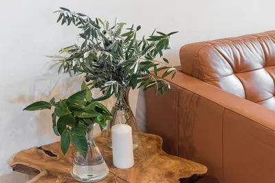 a table with a candle and a plant on it at GuestReady - Contemporary cabin in Santos Pousada in Porto