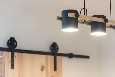 a row of lights hanging from a wall at GuestReady - Contemporary cabin in Santos Pousada in Porto