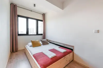 a bed in a room with a large window at GuestReady - Contemporary cabin in Santos Pousada in Porto
