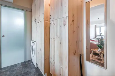 a bathroom with a wooden wall with a washing machine at GuestReady - Contemporary cabin in Santos Pousada in Porto