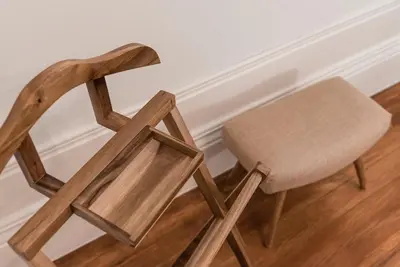 a wooden chair sitting next to a wall at GuestReady - Naoki Studio in Porto