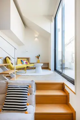 two glasses of orange juice sitting on a pink table at Duque de Saldanha Duplex Loft in Porto