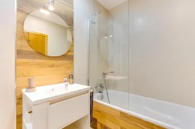 a bathroom with a white sink and a mirror at Cozy Nest in Porto