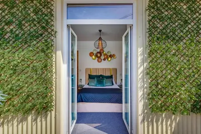 a hallway leading to a bedroom with a bed at Cozy Nest in Porto