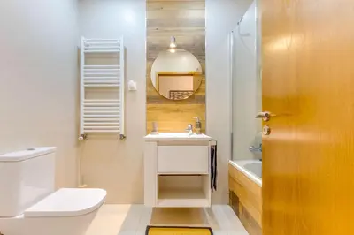 a bathroom with a toilet and a sink and a mirror at Cozy Nest in Porto