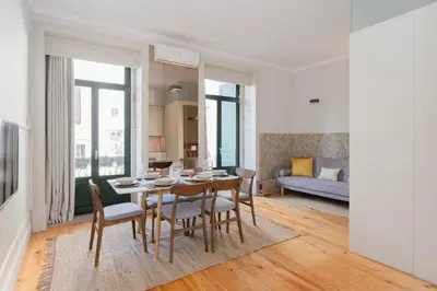 a dining room and living room with a table and chairs at Liiiving in Porto - Bolhao Garden Apartment in Porto