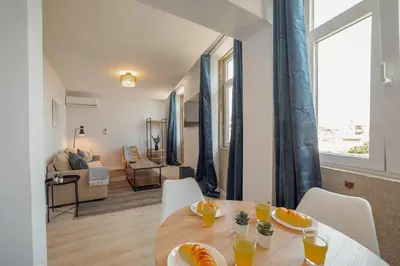 a dining room with a table with oranges on it at Alegria Duplex by Hosty in Porto