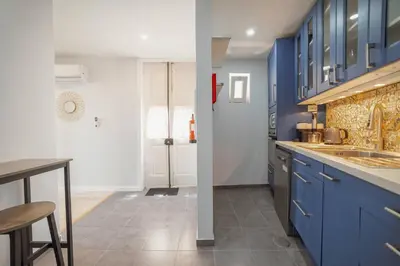 a blue kitchen with a sink and a counter at Alegria Duplex by Hosty in Porto