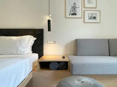 a bedroom with two beds and a nightstand next to a bed sidx sidx sidx at Essência Portuense Studios in Porto