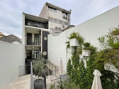 a white building with stairs and plants in front of it at Essência Portuense Studios in Porto