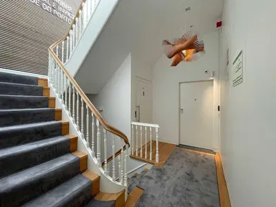 a staircase in a house with a ceiling fan at Essência Portuense Studios in Porto