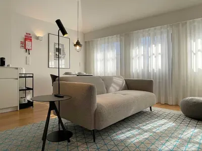 a living room with a couch and a table at Essência Portuense Studios in Porto