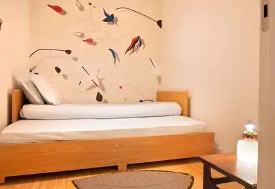 a bedroom with a bed with birds on the wall at Take me to Aliados in Porto
