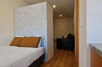 a bedroom with a bed and a wall at Tomás FLAT 4F in Porto