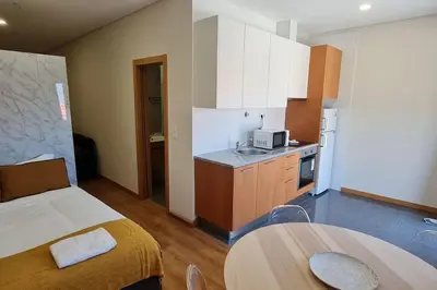 a kitchen with a bed and a table in a room at Tomás FLAT 4F in Porto