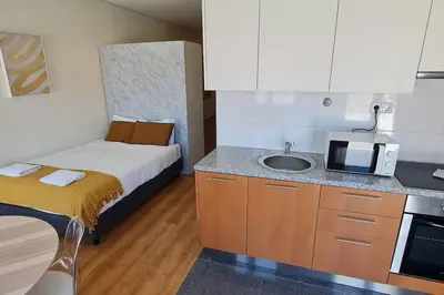 a small kitchen with a bed and a sink at Tomás FLAT 4F in Porto