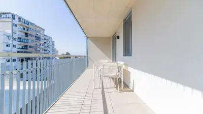 a balcony with chairs and a view of a building at Infante Studio w Parking by LovelyStay in Vila Nova de Gaia