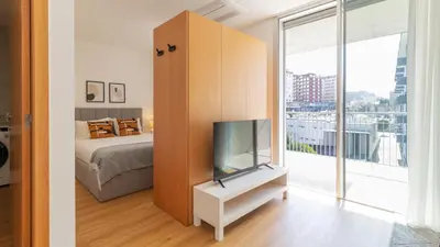 a bedroom with a bed and a tv on a cabinet at Infante Studio w Parking by LovelyStay in Vila Nova de Gaia