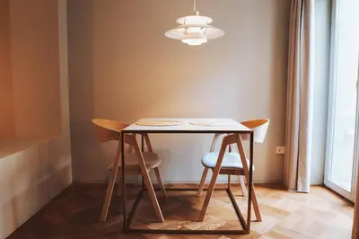 a table with two chairs and a light at Domum 4 in Porto