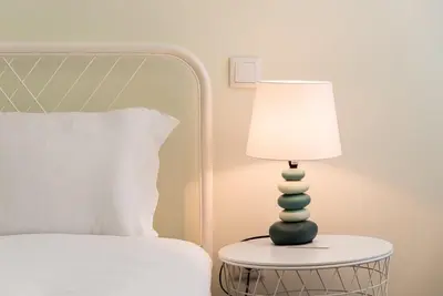 a lamp sitting on a table next to a bed at GuestReady - Lightform Apartment in Porto