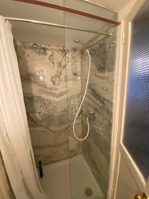 a shower with a glass door in a bathroom at Aliados Historic Downtown Apartments by LuxiStay in Porto