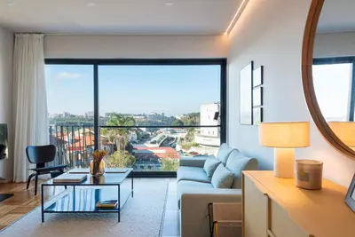 a living room with a couch and a table at Aires Gouveia Penthouse in Porto