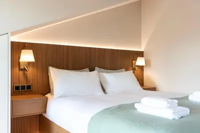 a bedroom with a large bed with white pillows at Aires Gouveia Penthouse in Porto