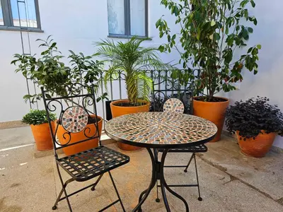 a table and two chairs sitting next to plants at Authentic Porto Village in Porto