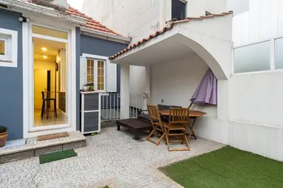 a patio with a table and chairs on a house at GuestReady - Le Jardin Secret in Porto