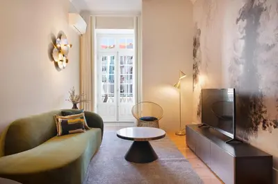 a living room with a couch and a tv at 42 1T Cardosas Block Historic Ap in Porto