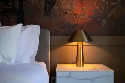 a lamp on a night stand next to a bed at 42 1T Cardosas Block Historic Ap in Porto