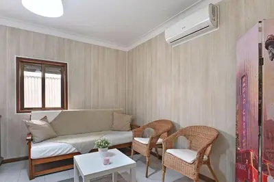 a living room with a couch and two chairs at Bessa - Casinha Típica do Porto com dois quartos in Porto