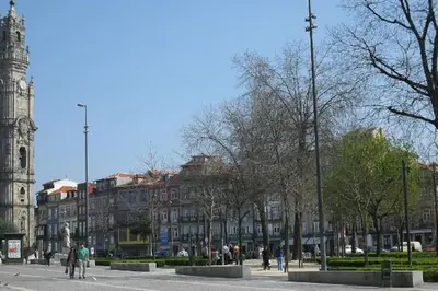 a city street with a clock tower and a building at Bessa - Casinha Típica do Porto com dois quartos in Porto
