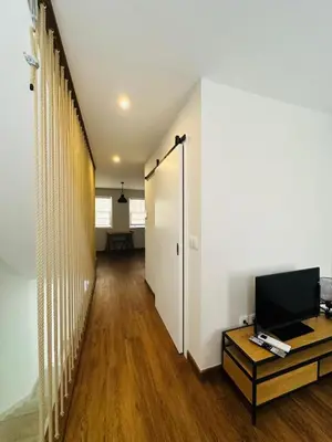 a room with a hallway with a tv and a table at Bridge Apartment in Porto