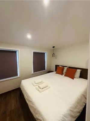 a bedroom with a large white bed with two towels on it at Bridge Apartment in Porto