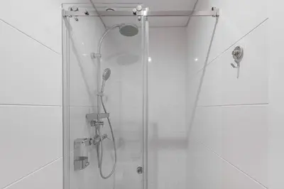a shower with a glass door in a bathroom at GuestReady - Riverview Douro Balcony in Vila Nova de Gaia