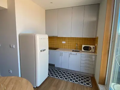 a kitchen with a white refrigerator and a microwave at Peter Terrace - Rio Douro & Caves Vinho do Porto in Bandeira