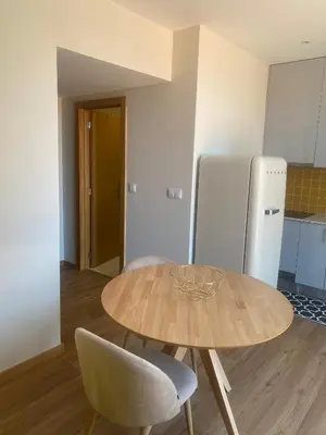 a kitchen with a table and two chairs and a refrigerator at Peter Terrace - Rio Douro & Caves Vinho do Porto in Bandeira