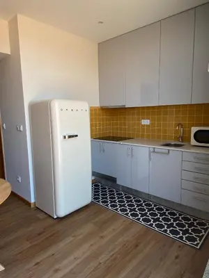 an empty kitchen with a white refrigerator in it at Peter Terrace - Rio Douro & Caves Vinho do Porto in Bandeira