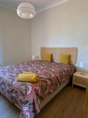 a bedroom with a bed with yellow pillows on it at Peter Terrace - Rio Douro & Caves Vinho do Porto in Bandeira