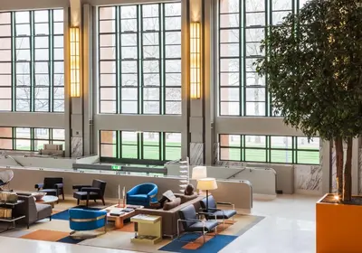 a lobby with couches and chairs and large windows at Vincci Porto in Porto
