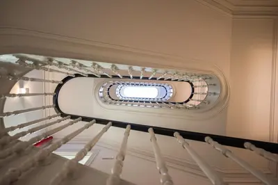 a spiral staircase with a window in the ceiling at HM Loios charming loft in Porto