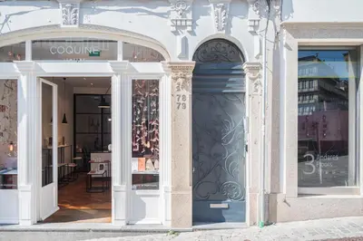 a white building with a store front with a door at HM Loios charming loft in Porto