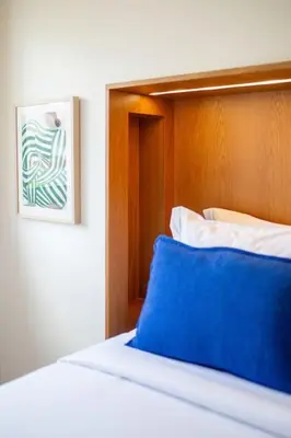 a bedroom with a bed with a blue pillow at Dixo's Oporto Apartments Duplex in Porto