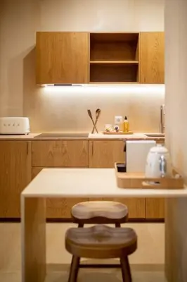 a kitchen with a wooden counter and a stool at Dixo's Oporto Apartments Duplex in Porto