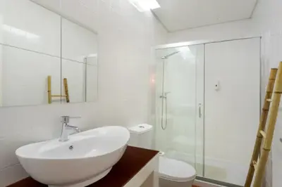 a white bathroom with a sink and a shower at Almada e Fado in Porto